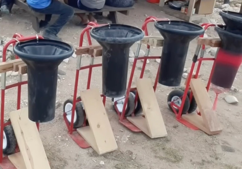 Original Adobe Ninja tools with black hoppers mounted on red hand trucks